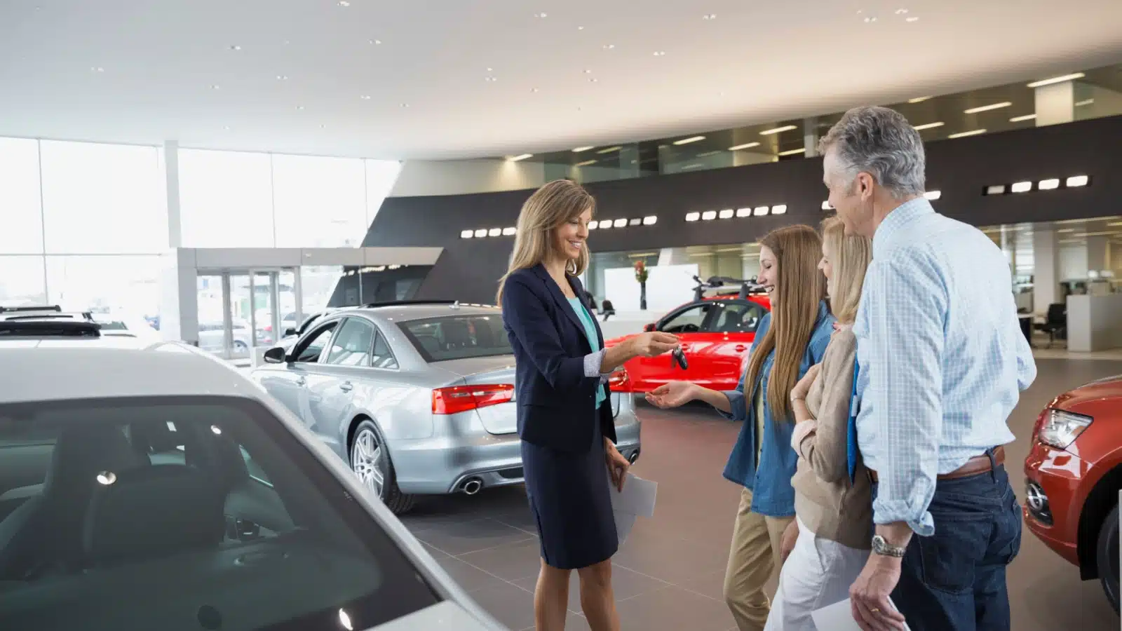 A teenager buying a new car with her parent's help.