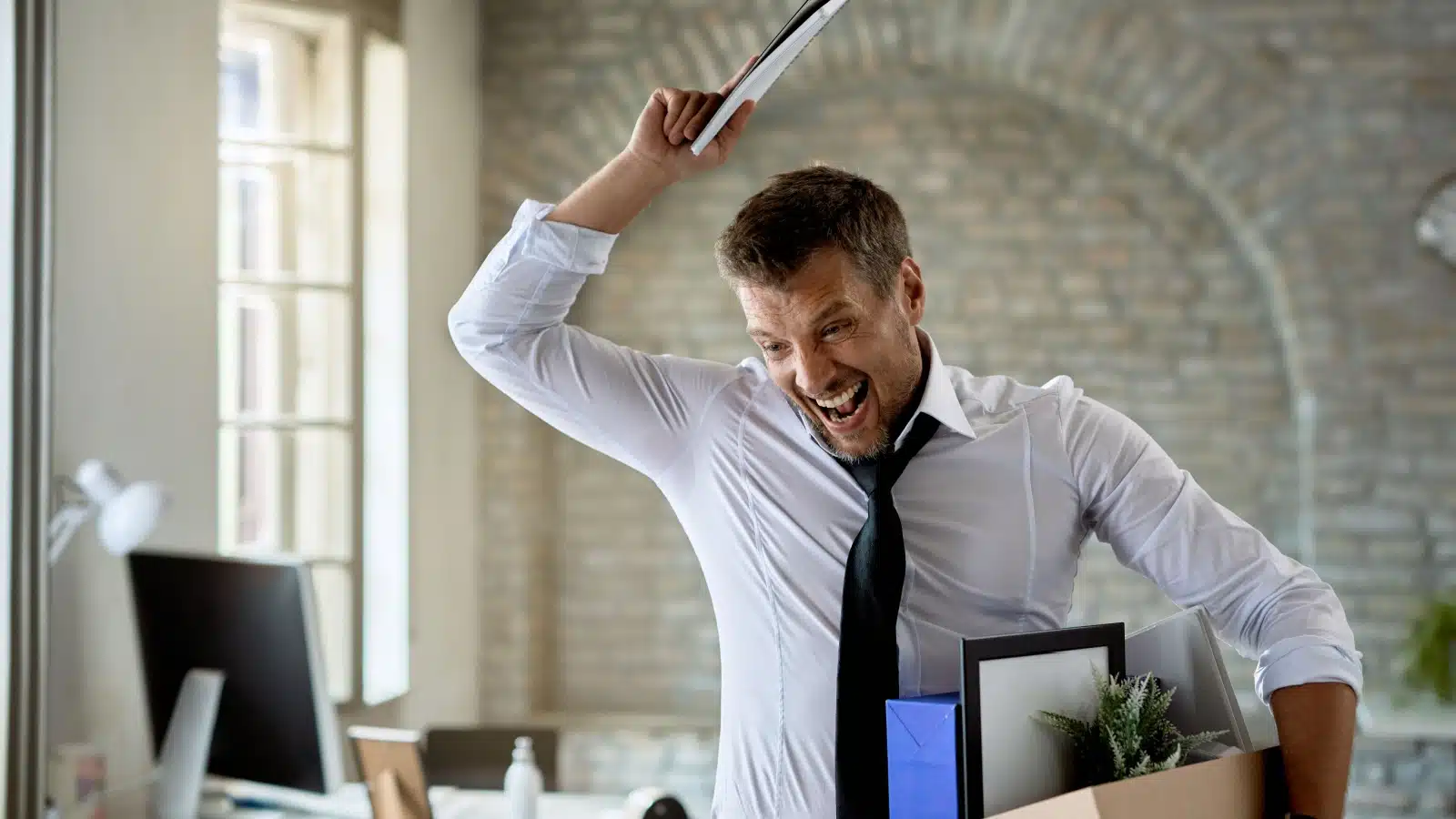 A man screams in anger as he quits his job.