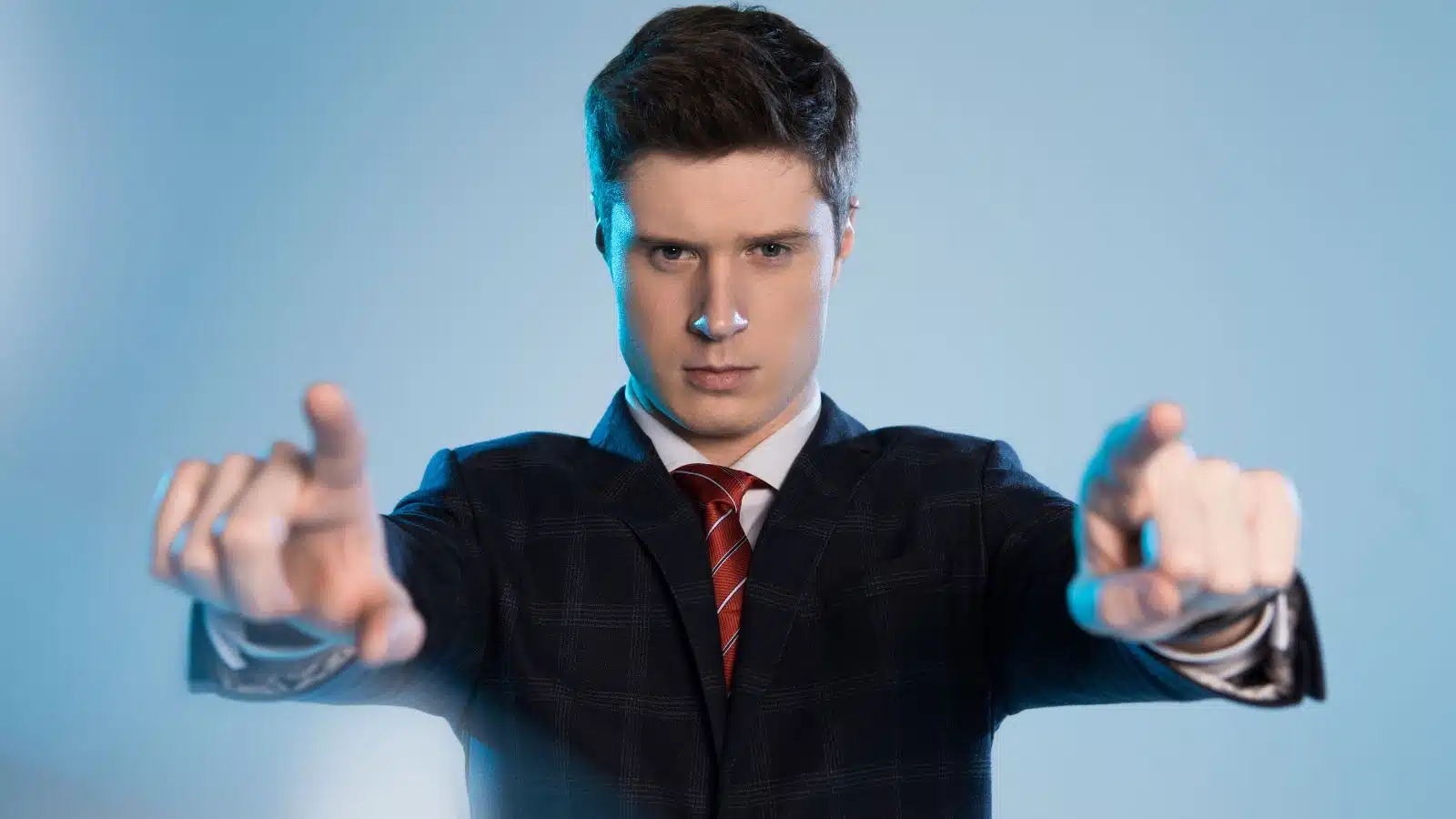 An arrogant business man pointing toward the audience as if to say he knows better than everyone. 
