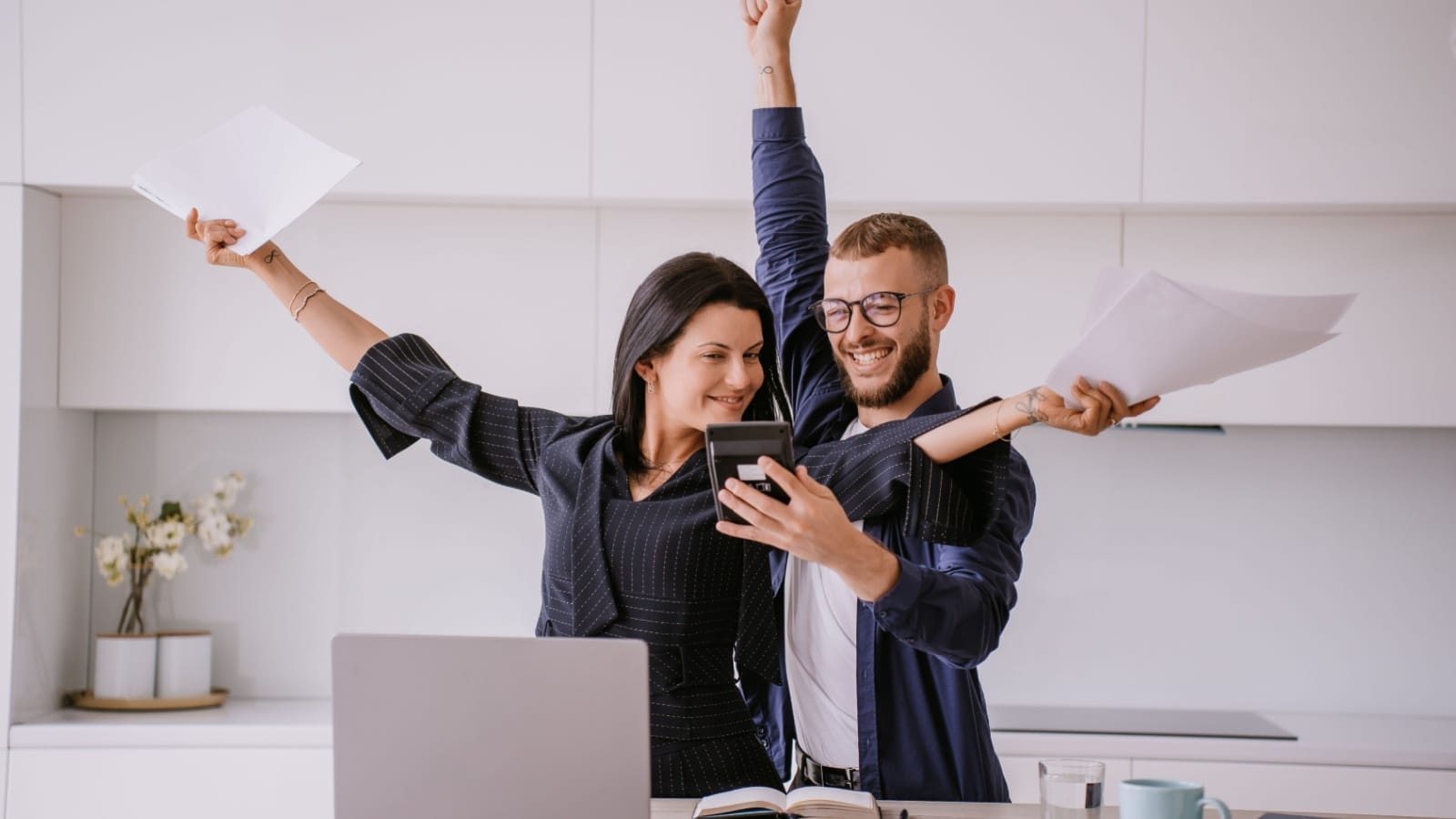 A happy couple celebrating their finances to represent what type of FIRE are you quiz.
