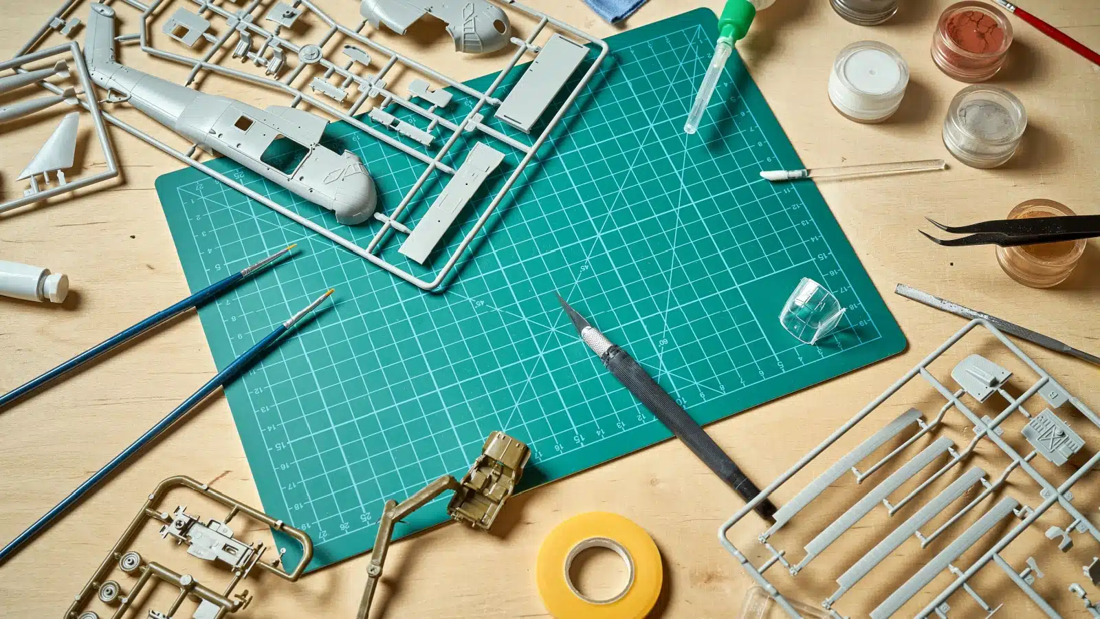 Kitbashing supplies gathered on a table. The hobbyist is ready to start kitbashing!