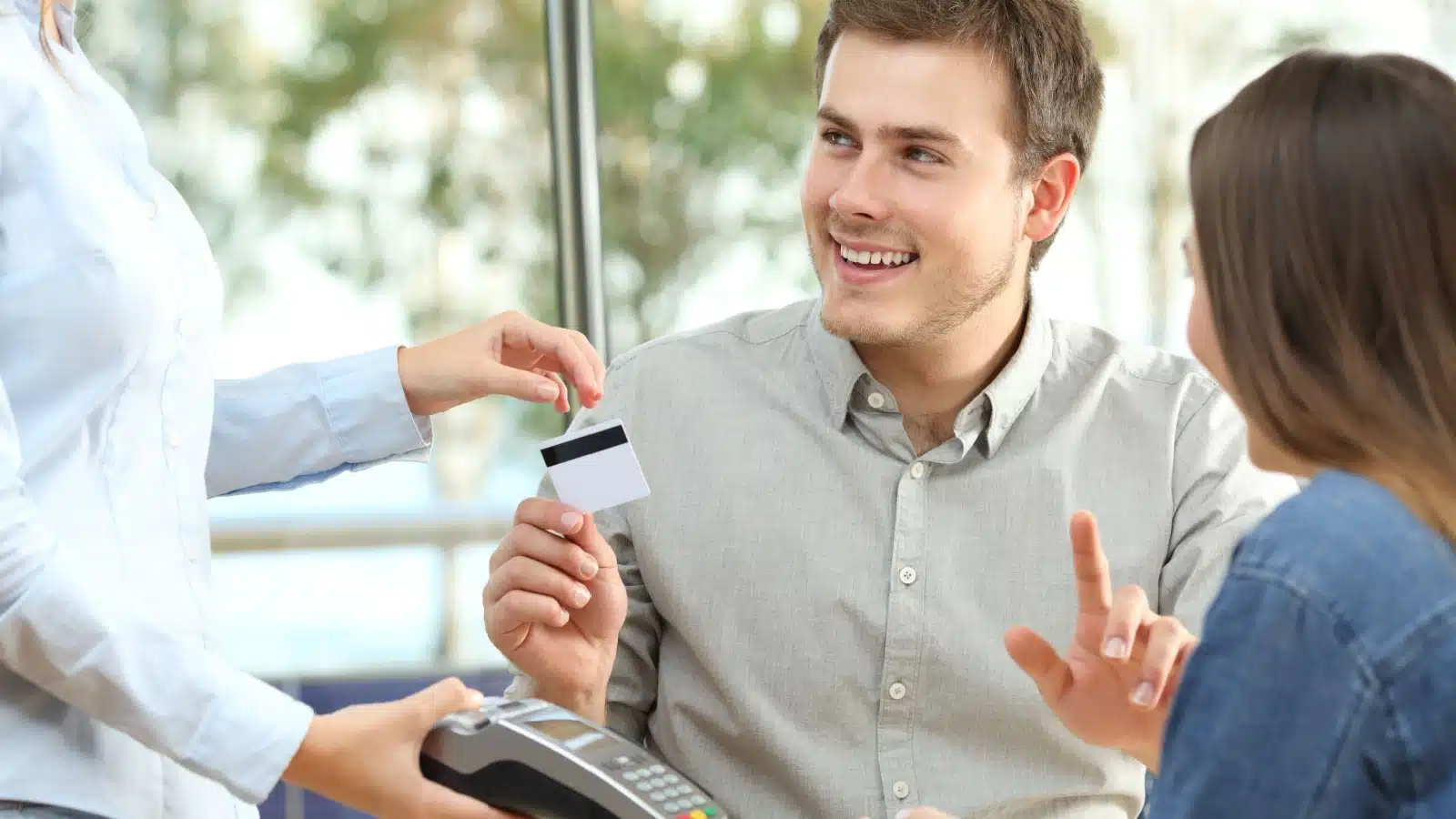 A man uses his card to pay for a date.