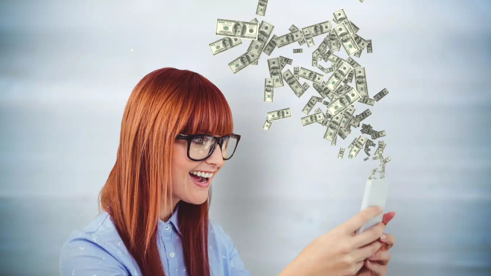 A happy woman holds her cell phone as cash flows out of it to represent making money with cash back apps.