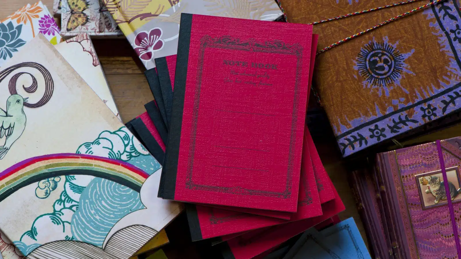 A stack of journals and notebooks represents the different types of journals.