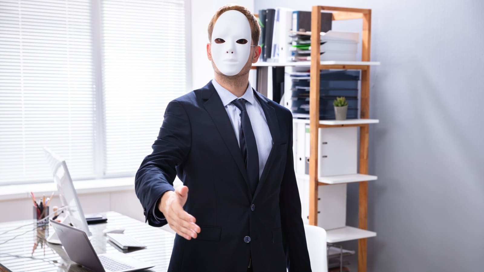 A manipulative salesman wearing a mask to represent unethical jobs.