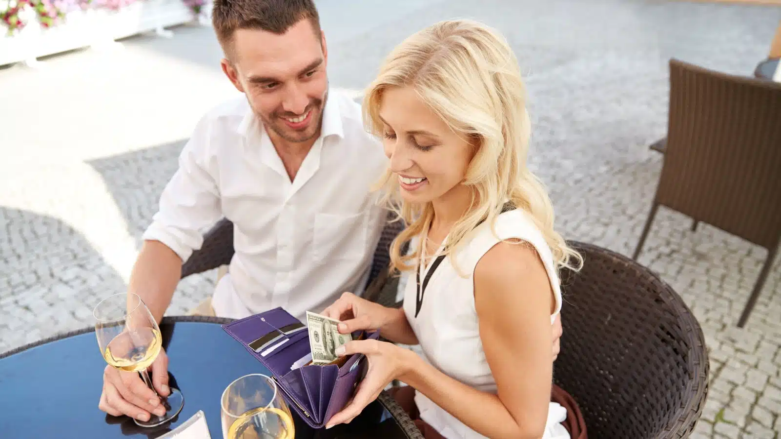 A woman uses cash to pay for a date.
