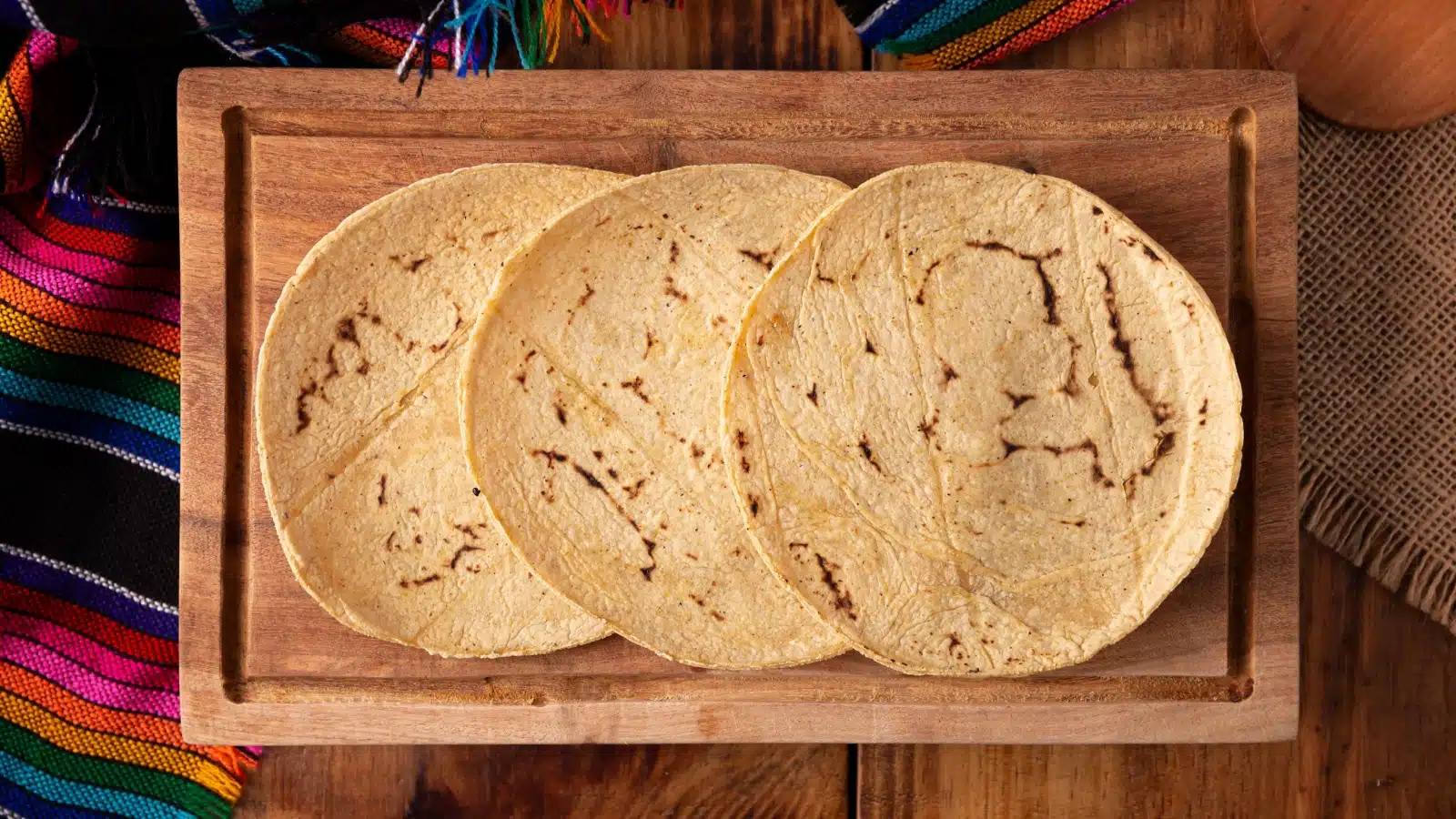 Three lightly fried corn tortillas ready to serve.