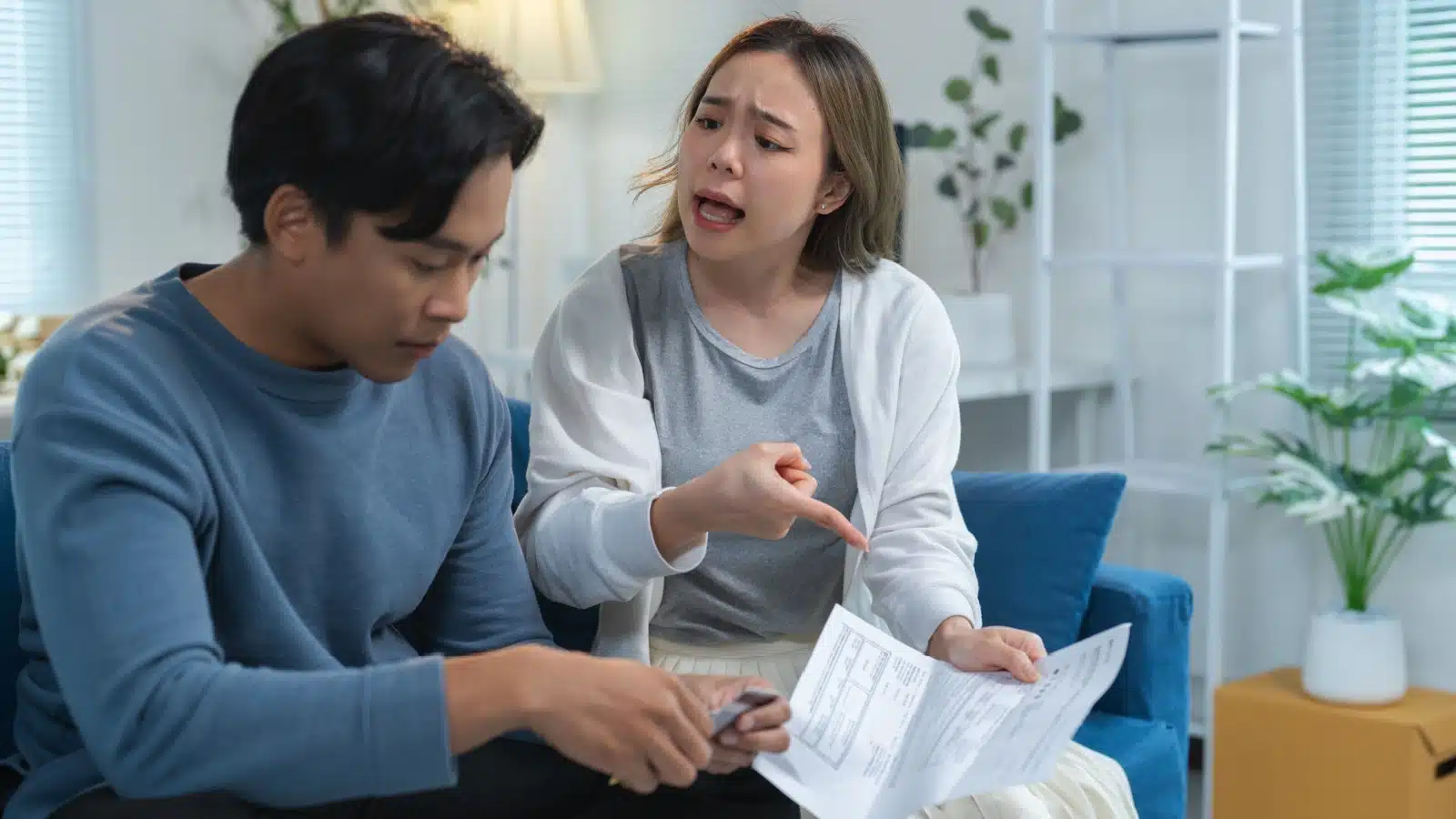 A woman argues with her husband over his spending habits.