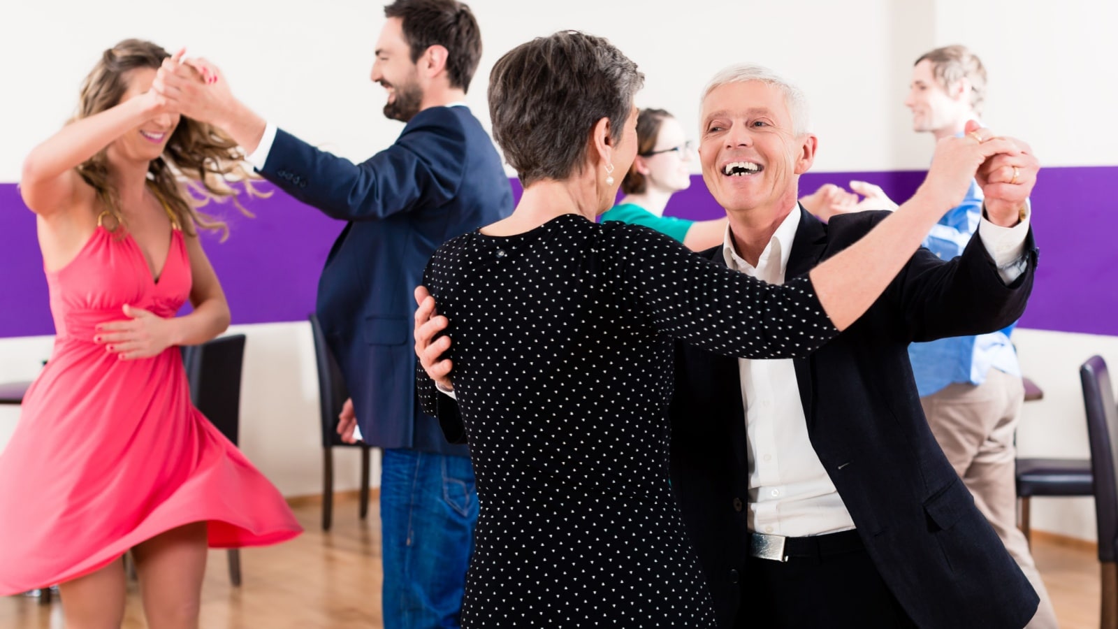 A group learning how to ballroom dance.