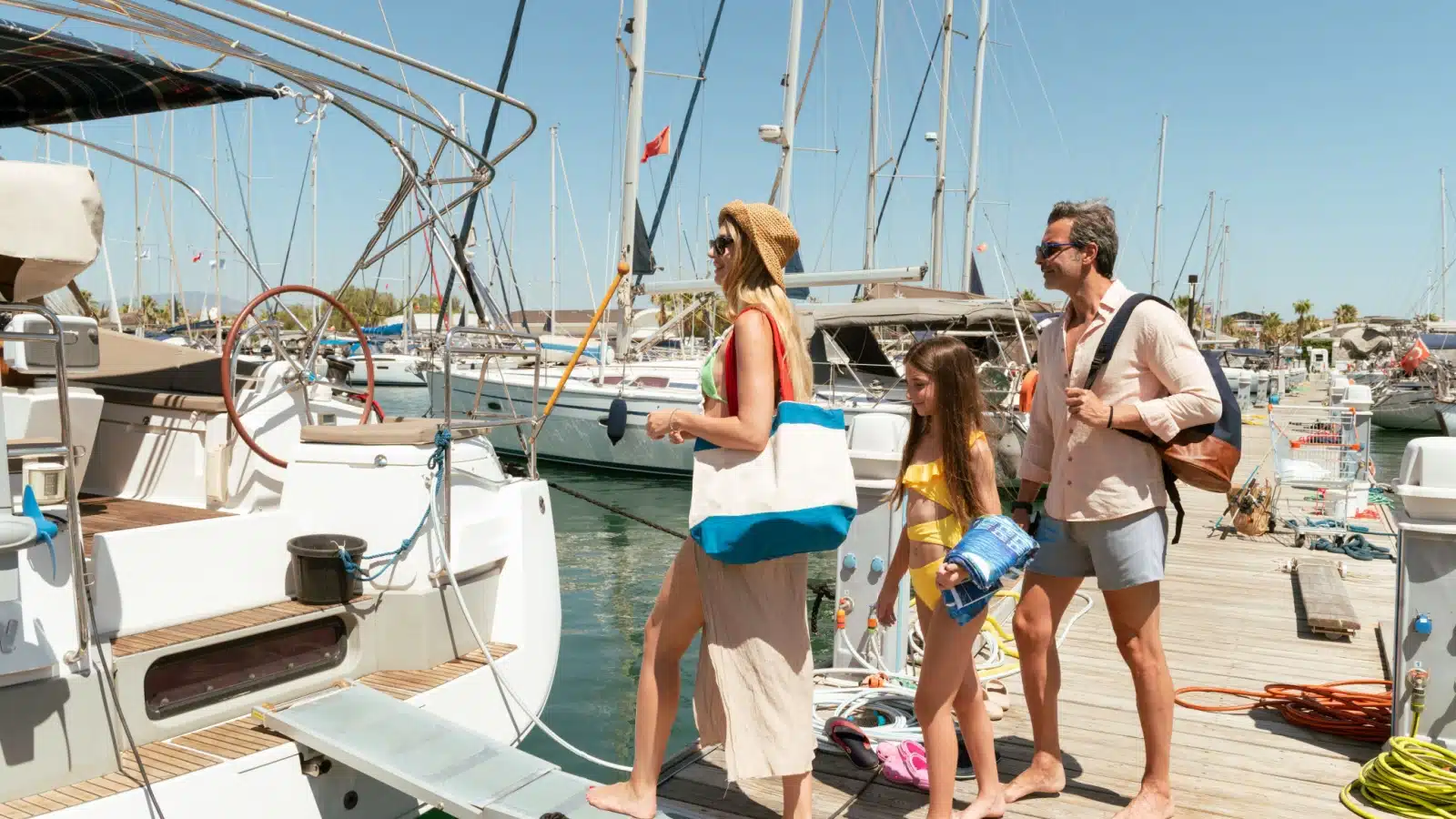 A family boards a boat they chartered.