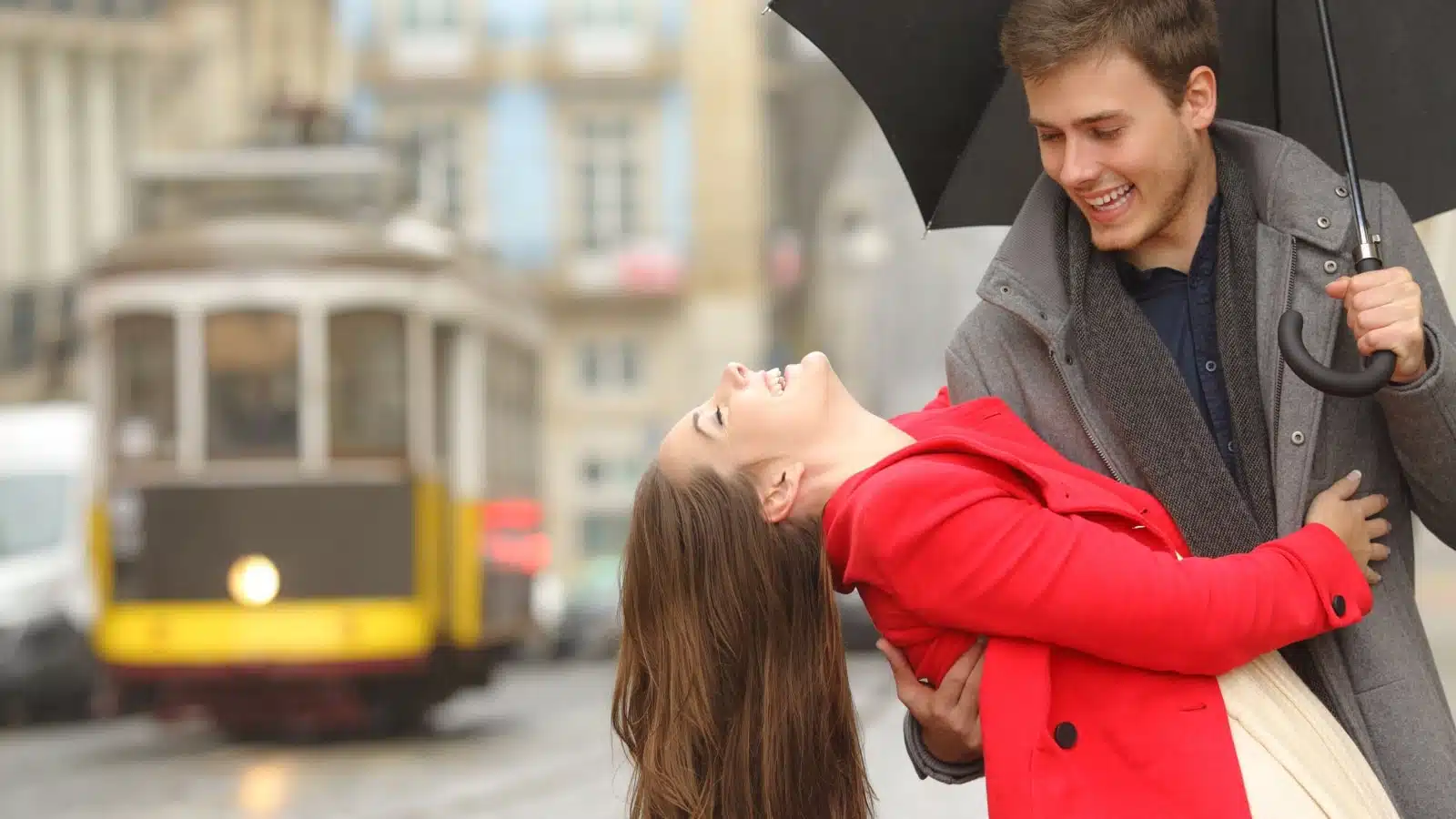 A happy couple enjoys a rainy day together.