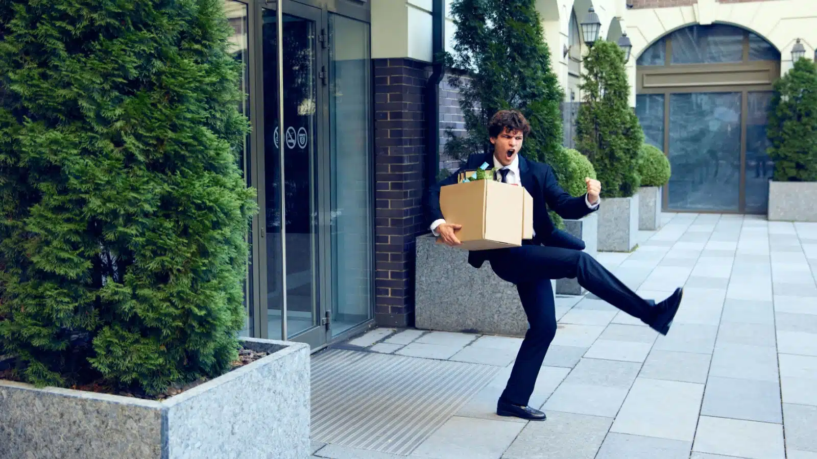 A man celebrates in the street after quitting his job.
