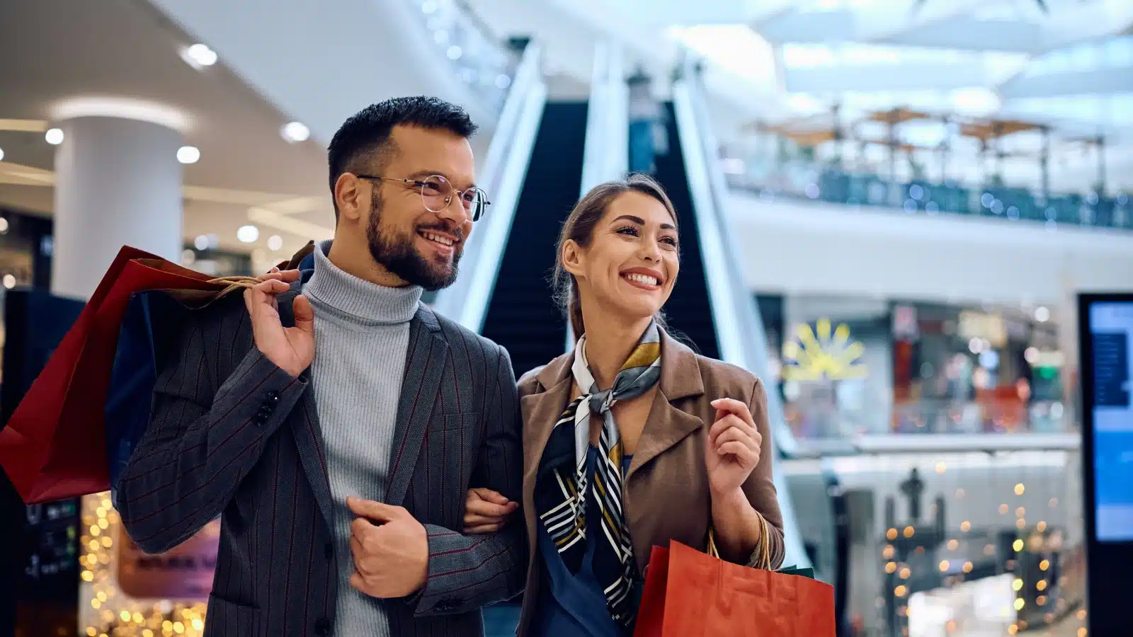 A happy couple shopping at the mall to represent the best things to spend money on.