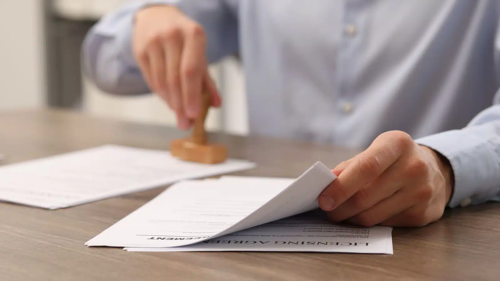 A man stamps approval for a regulatory document.