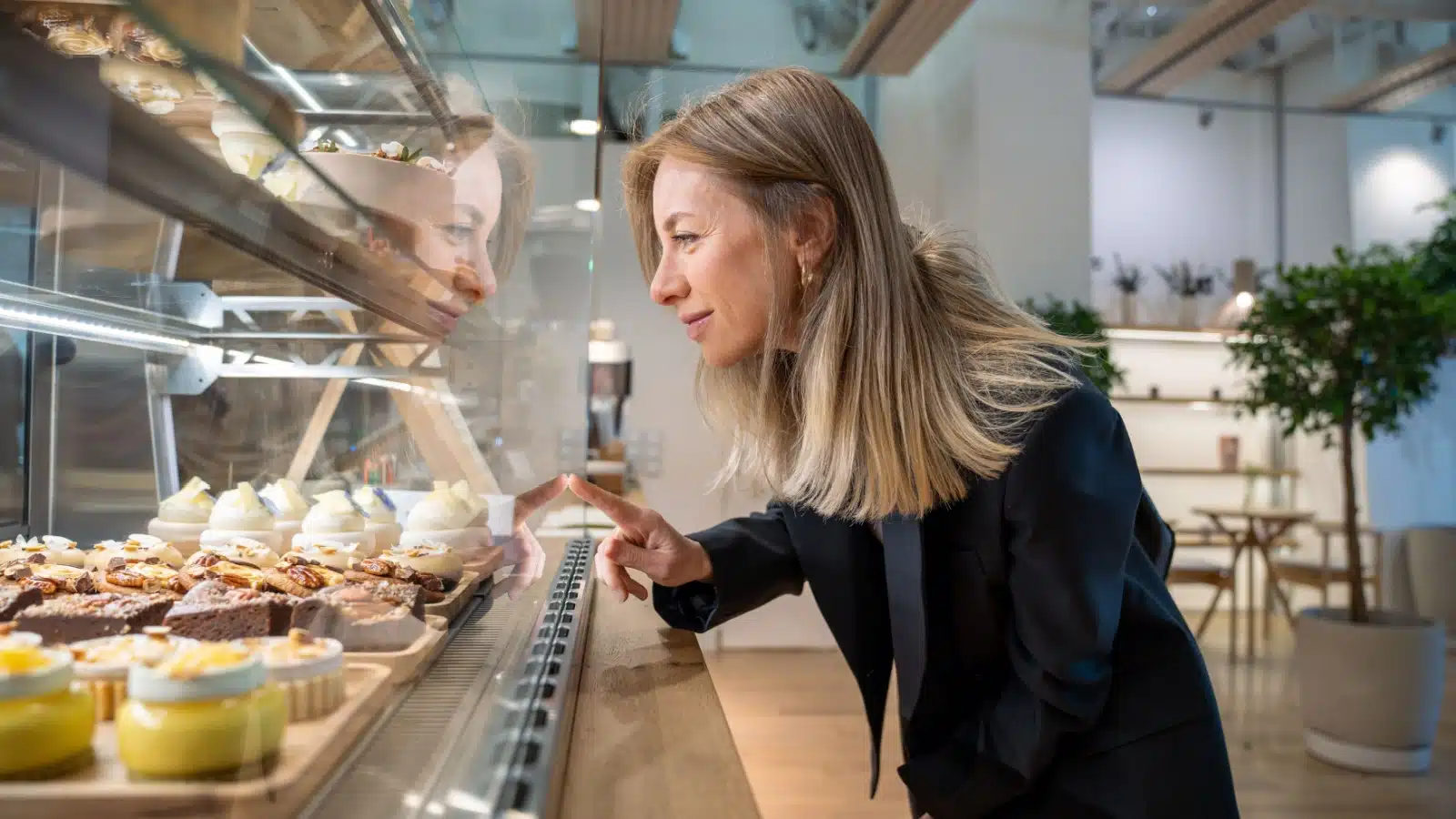 A woman purchases a pastry from a coffee shop.