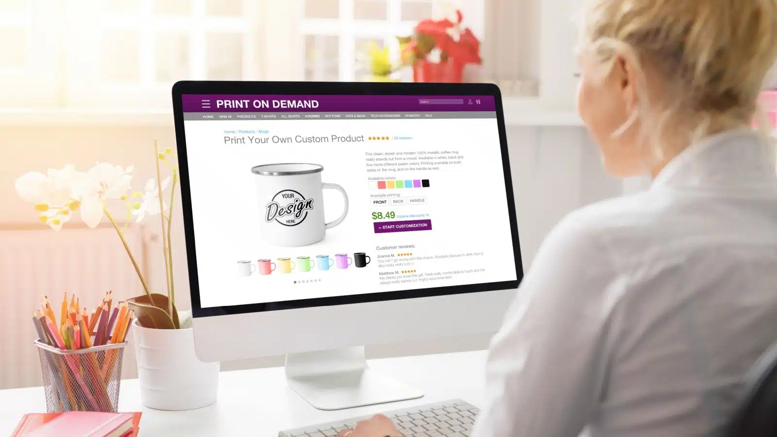A woman designs a mug on a print-on-demand platform, highlighting the different products you can design and sell.