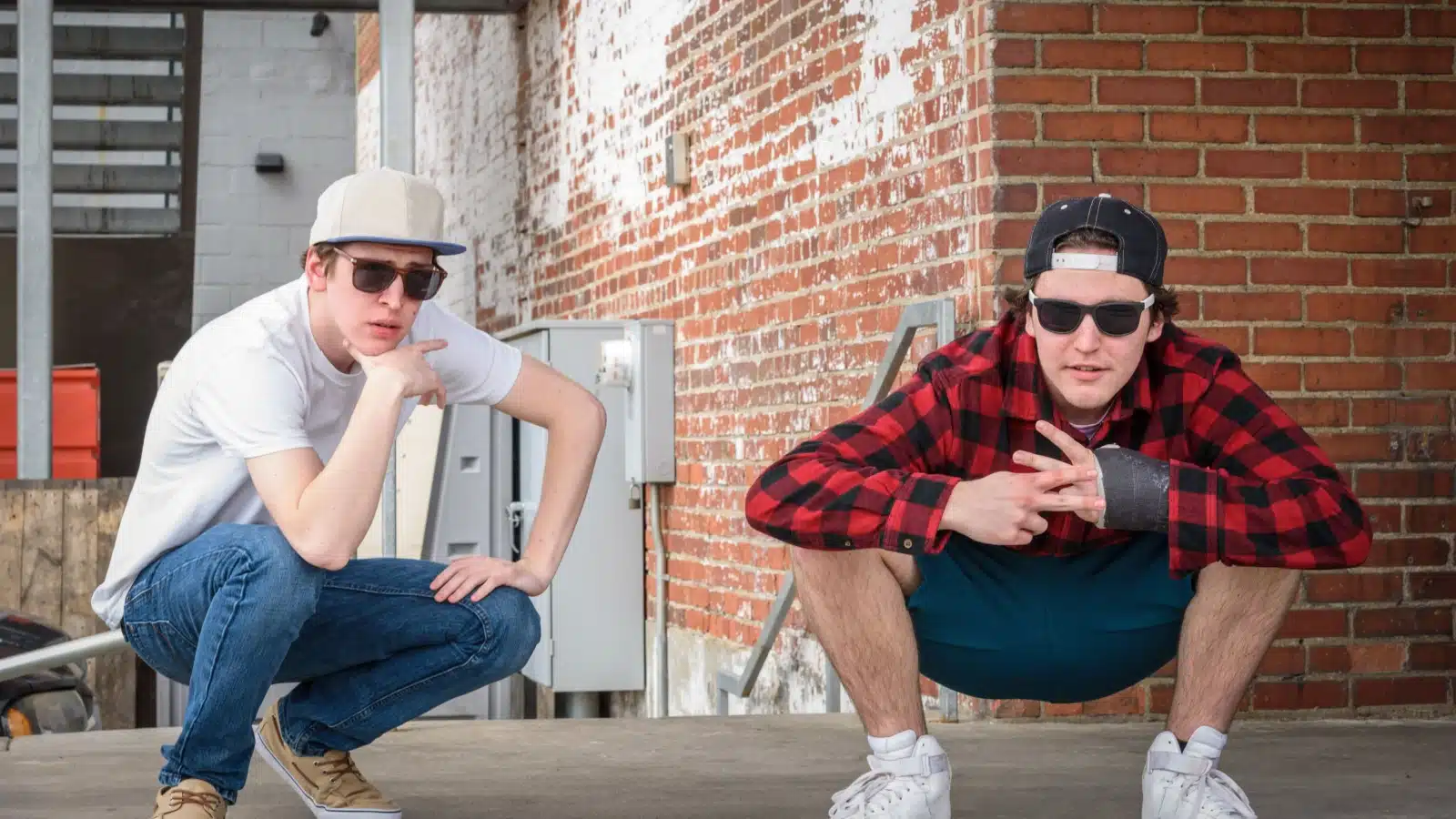 Teenagers squatting like Kriss Kross trying to look cool.