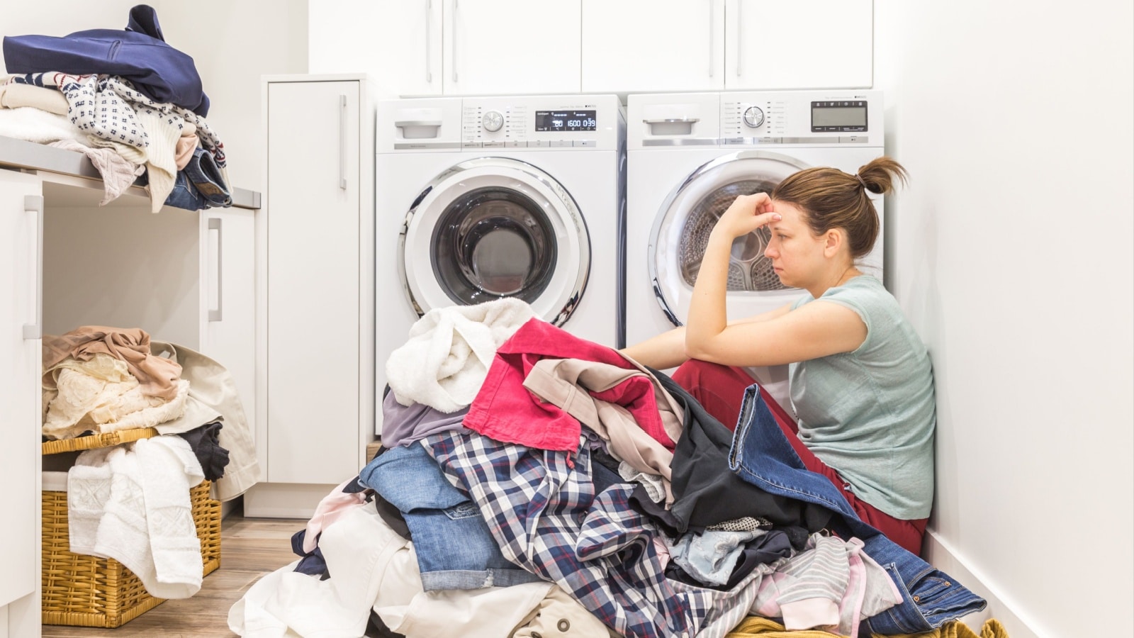 Tired woman with a big load of laundry to do.