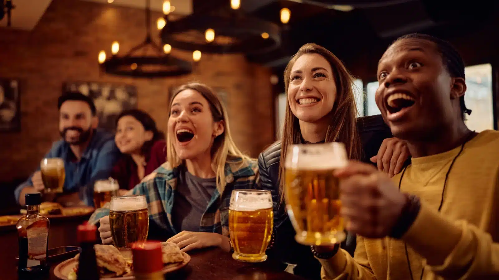 A group of friends enjoying pints at a bar.