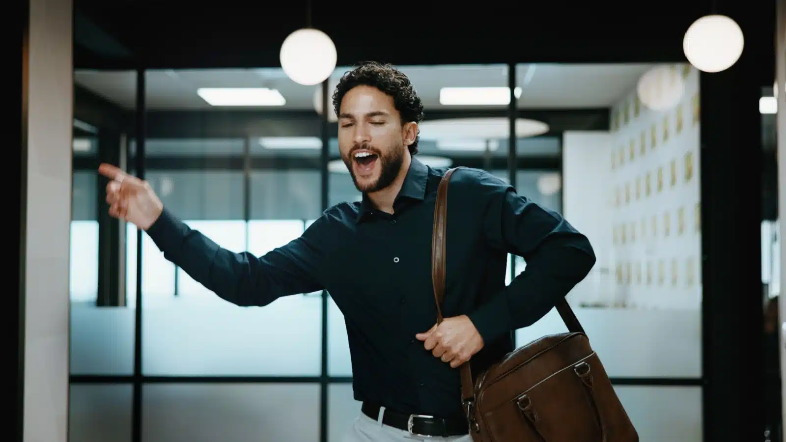 A happy man sings as he leaves work for the day.