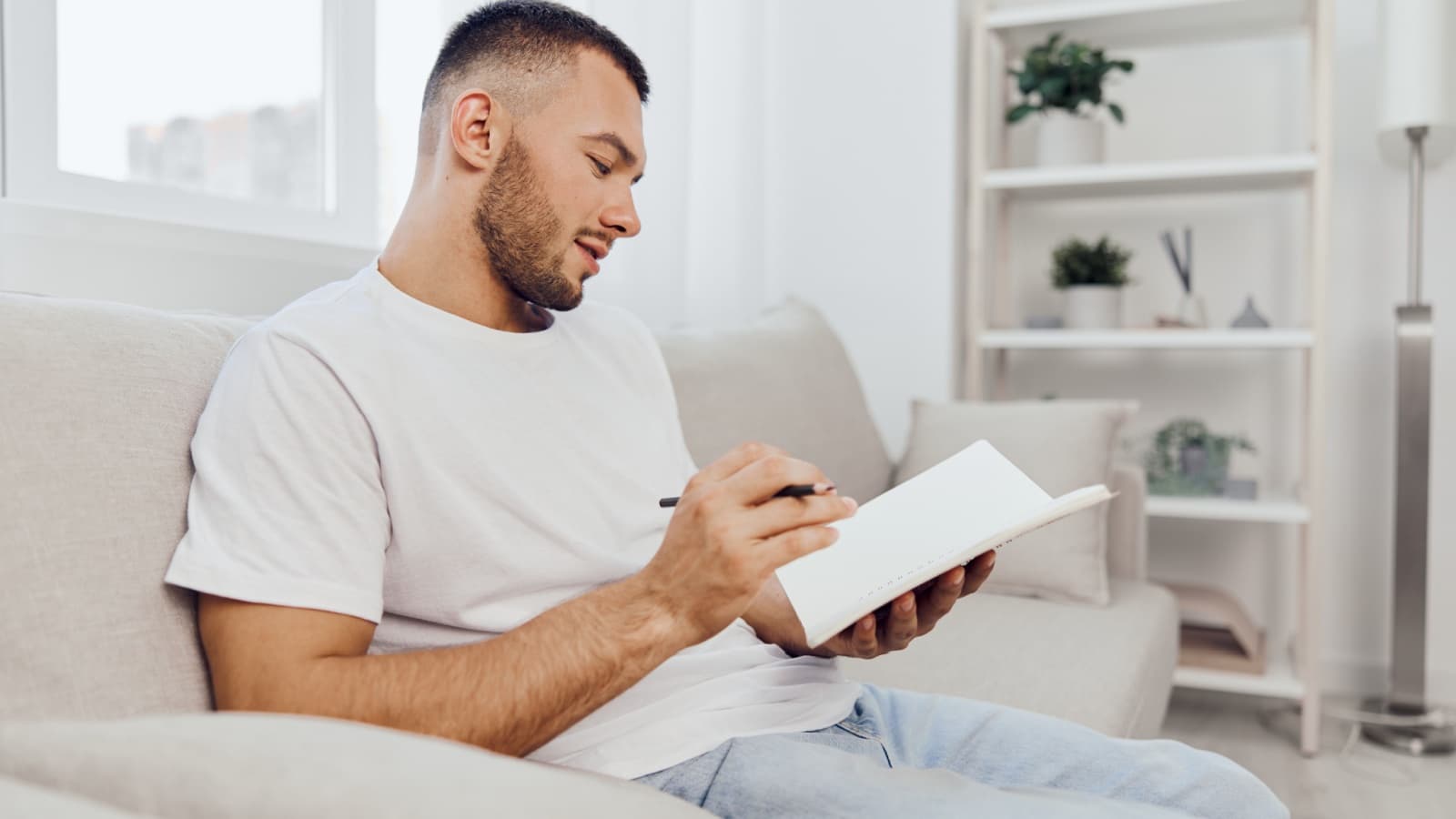 A thoughtful man journals for self-reflection.