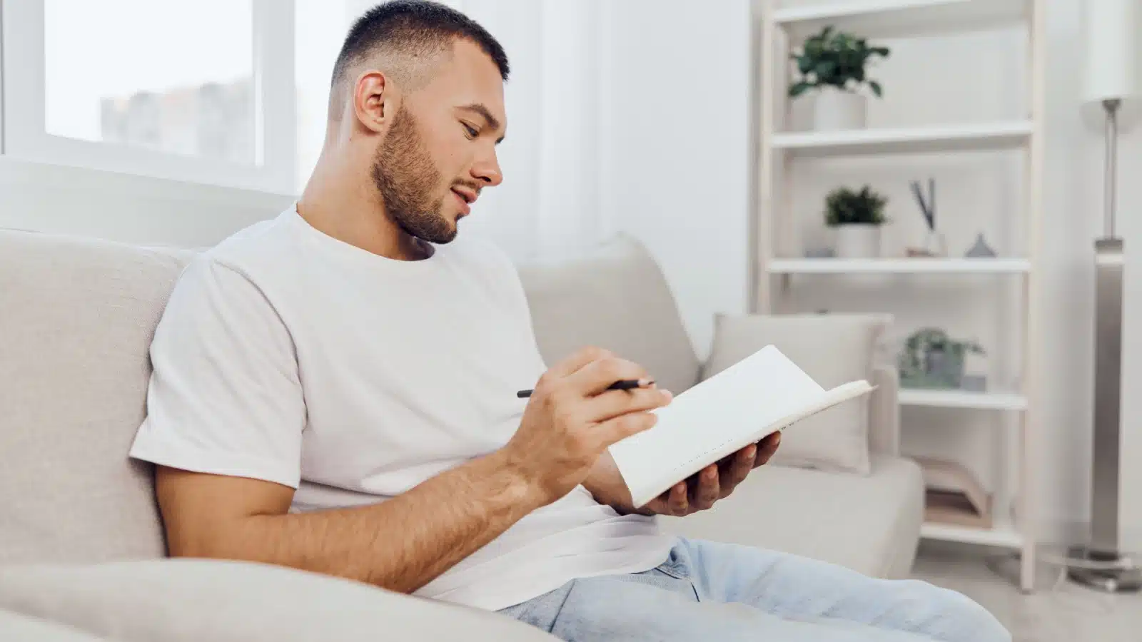 A thoughtful man journals for self-reflection.