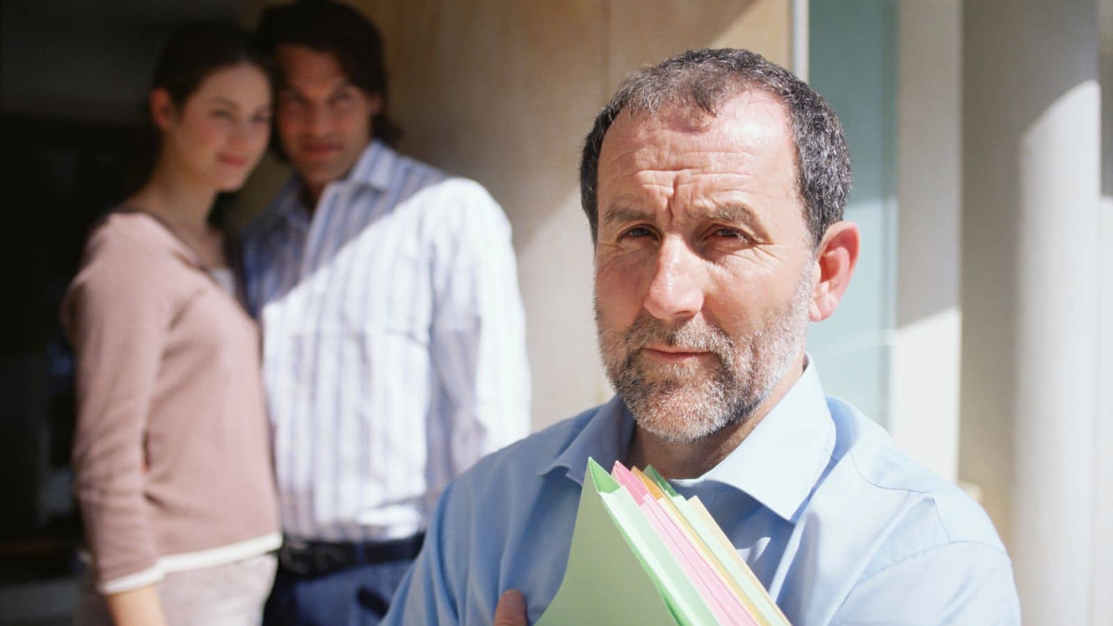 The unsure landlord stands in front of his renters. He wants to sell, but they've asked him to reconsider.