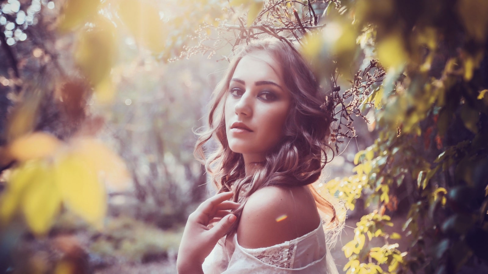 Portrait of a woman in the woods, wearing a crown of tree branches, to represent a Celtic woman.