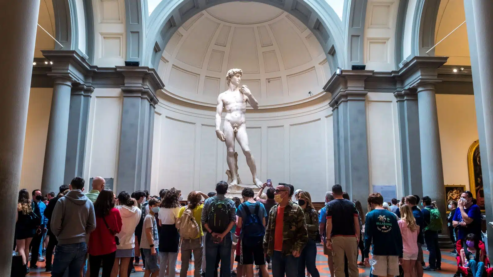 A crowd of tourists admiring Michelangelo's David. 