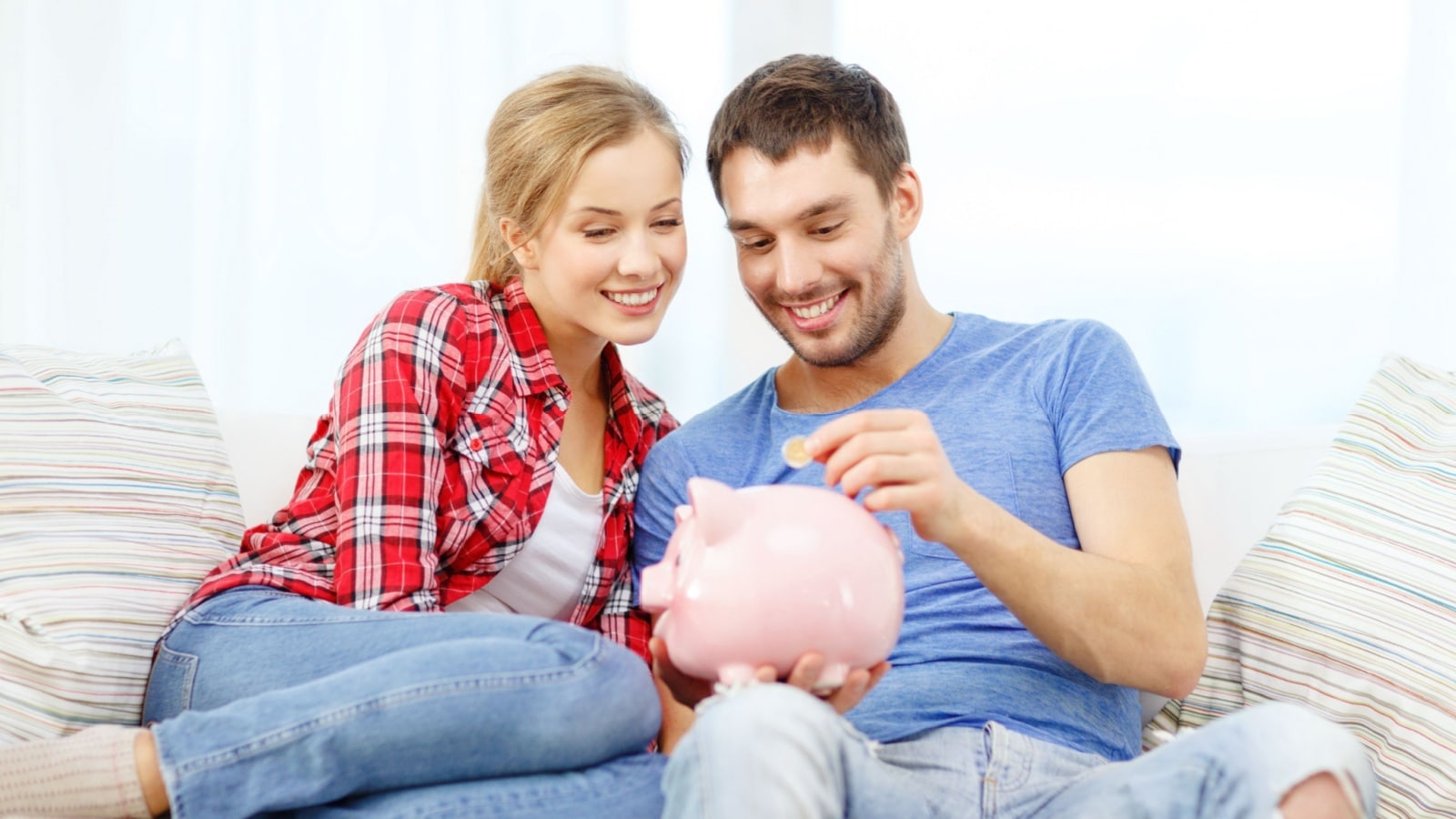 A middle class couple saving money in a piggy bank.