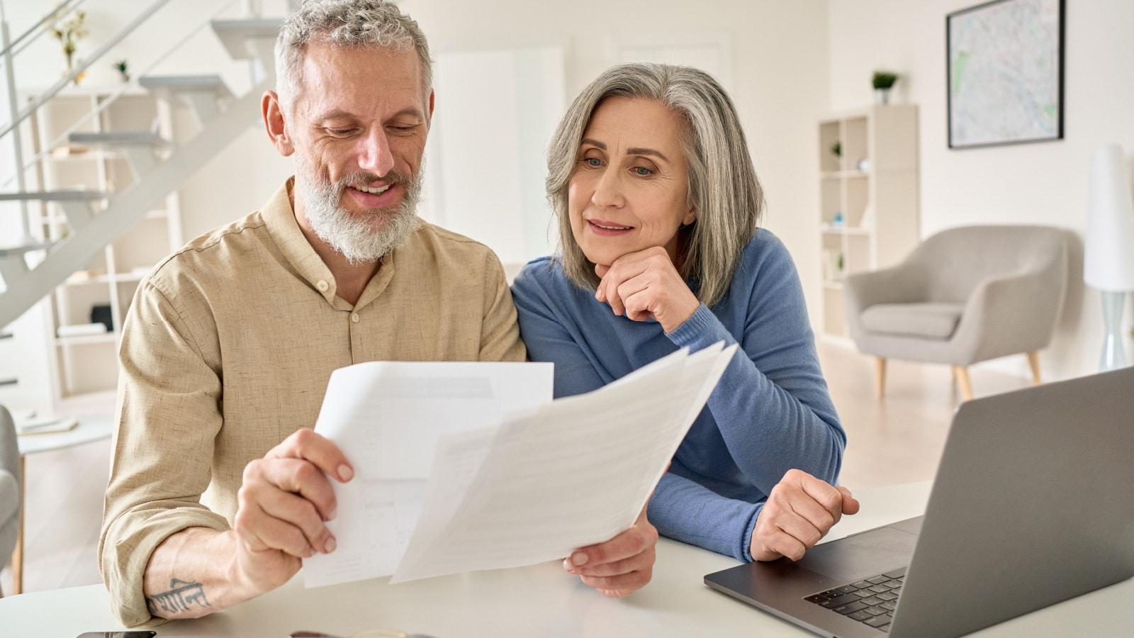 A retired couple looking at their financial statements.