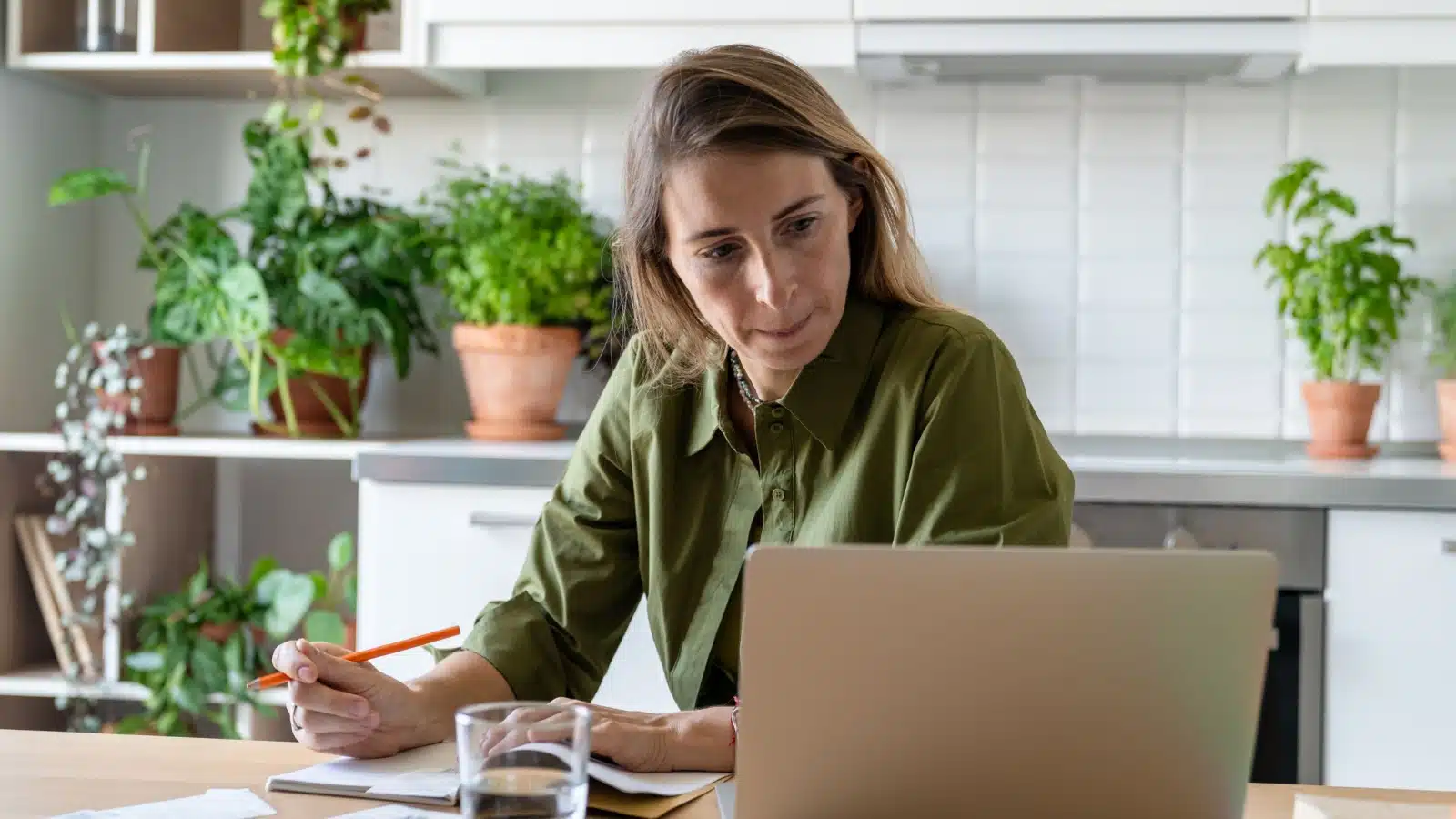 A stressed woman is making a budget.