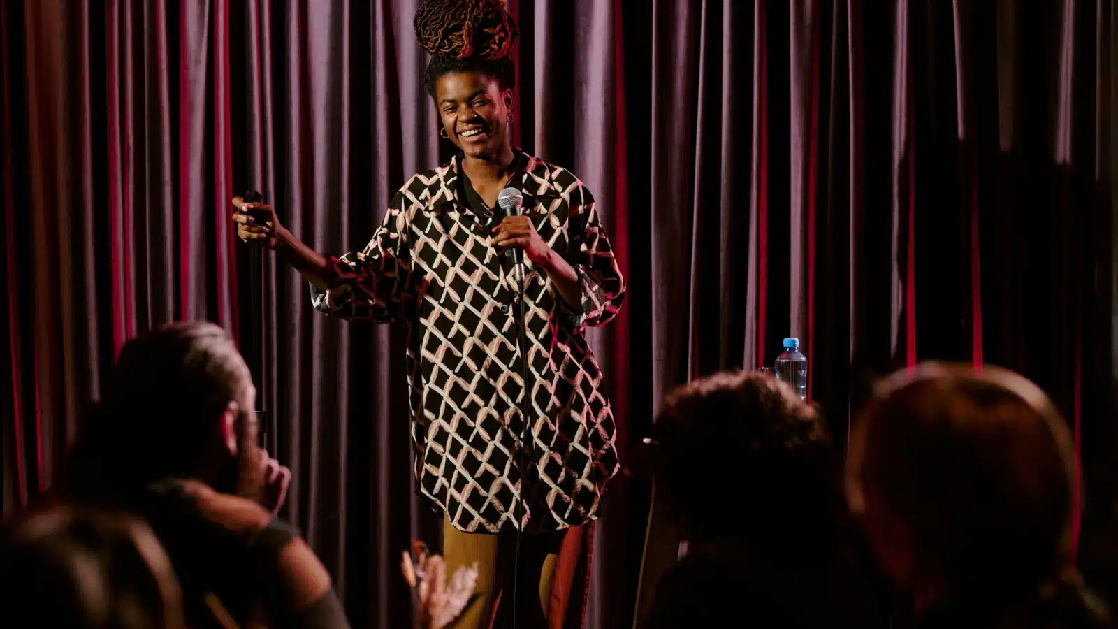 A comedian tells jokes at a standup comedy show.