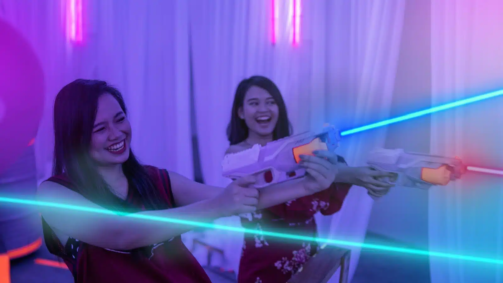 Girls playing a laser tag game.