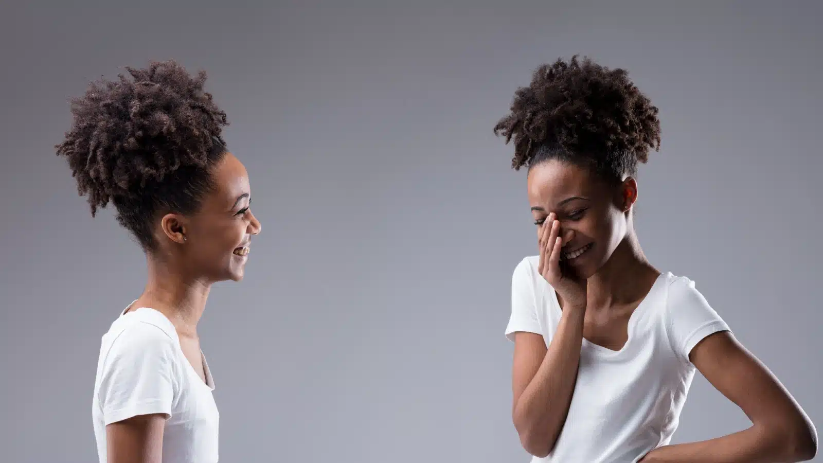 A woman smiles and laughs at herself.