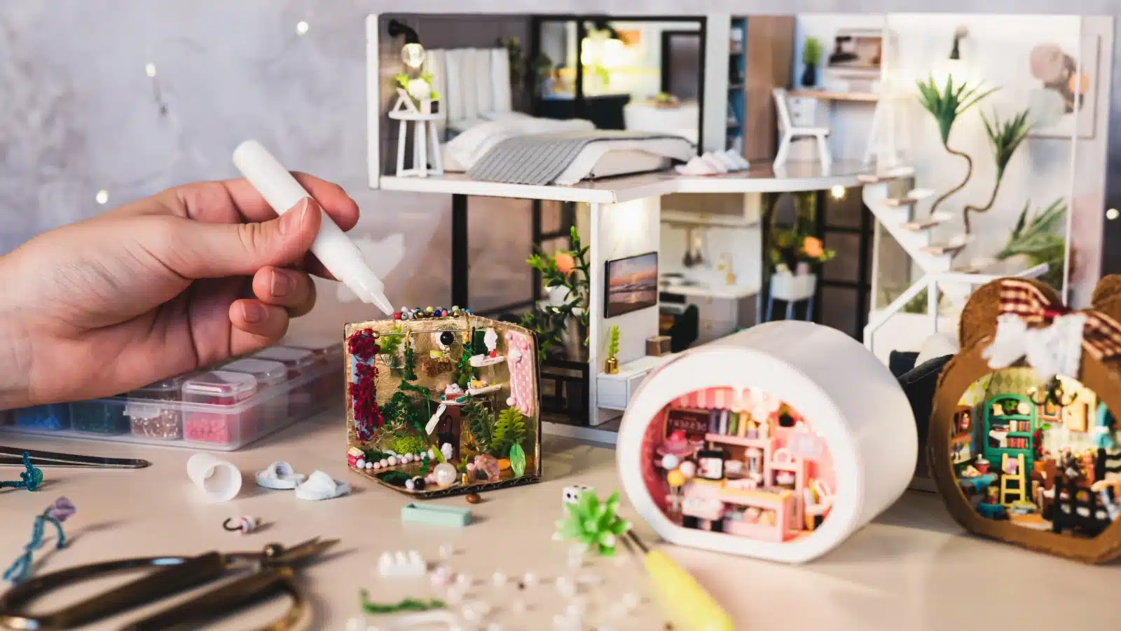 A girl makes miniature rooms for her miniature world.