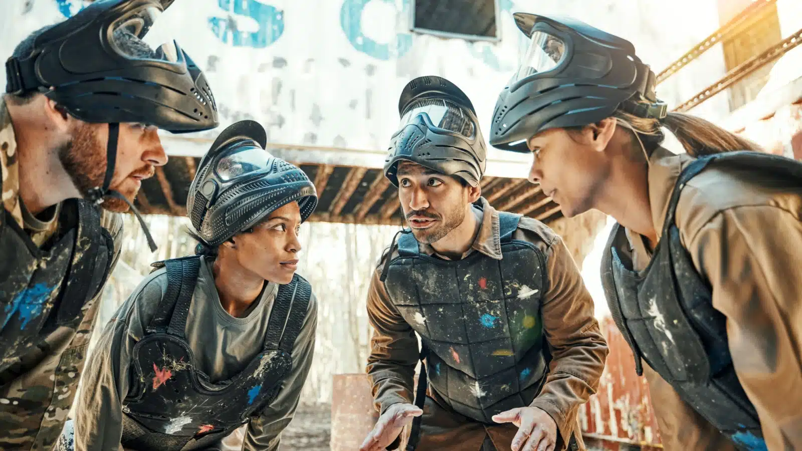 A paintball team discussing tactics.