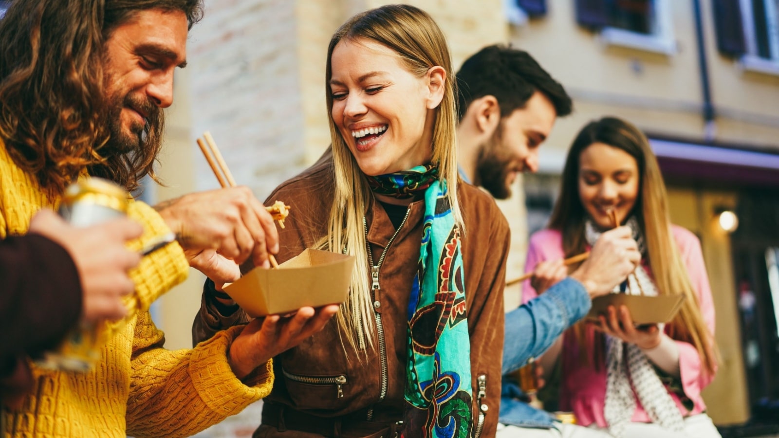 Friends enjoy street food to represent popular food trends.