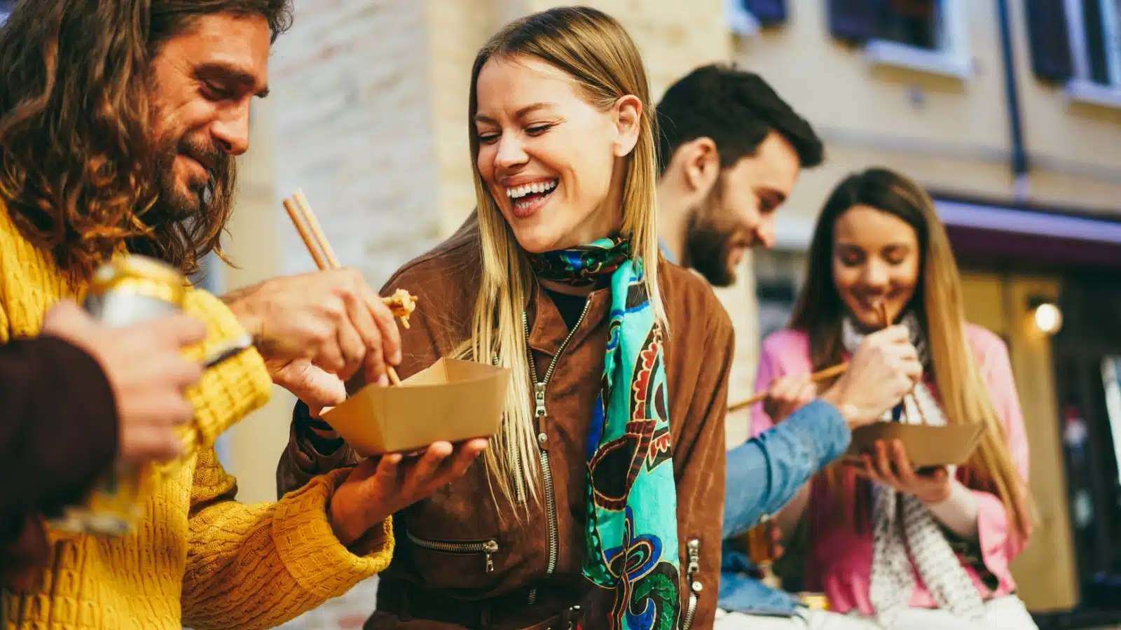 Friends enjoy street food to represent popular food trends.