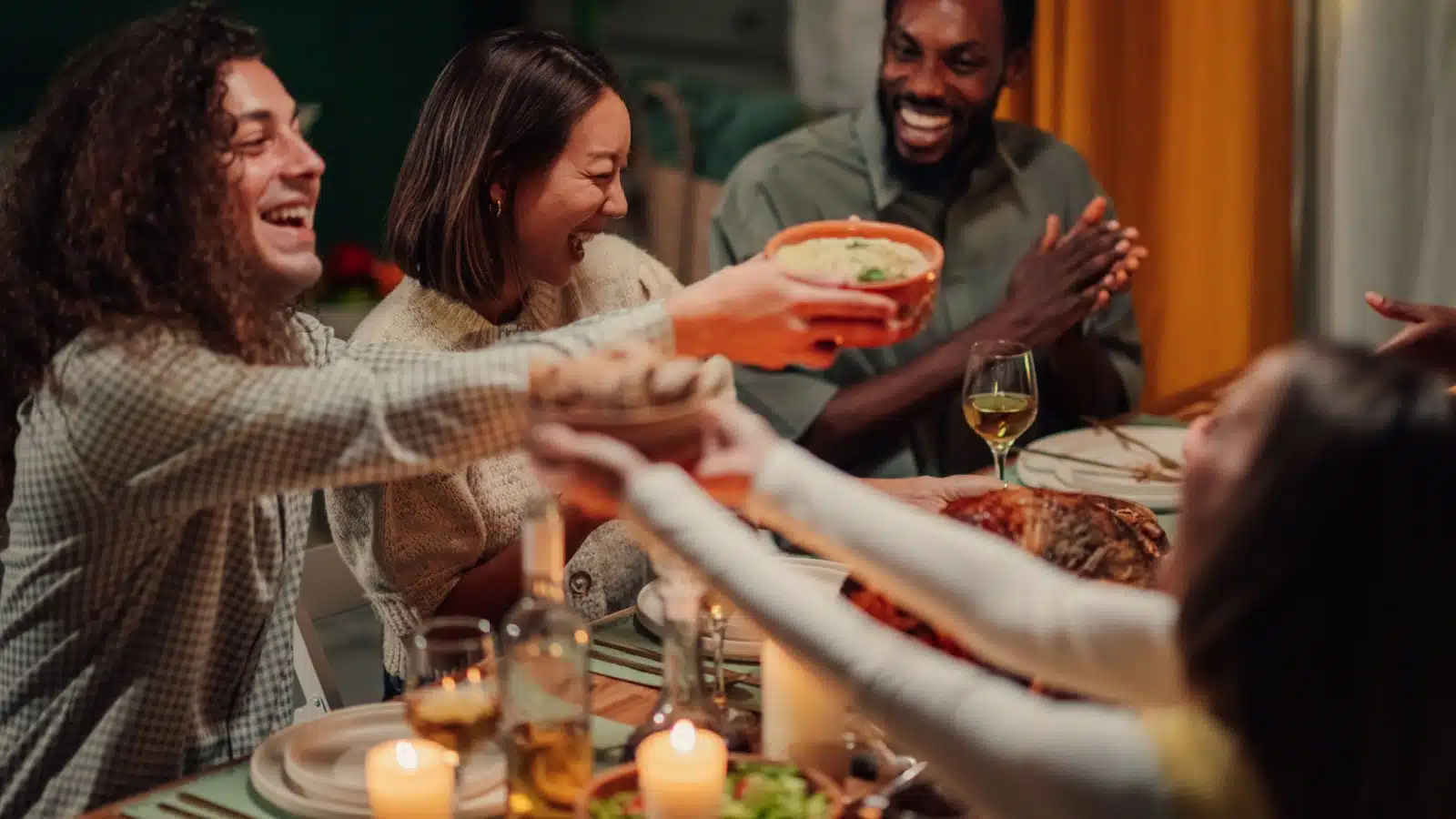 Friends sharing food at a potluck dinner party.
