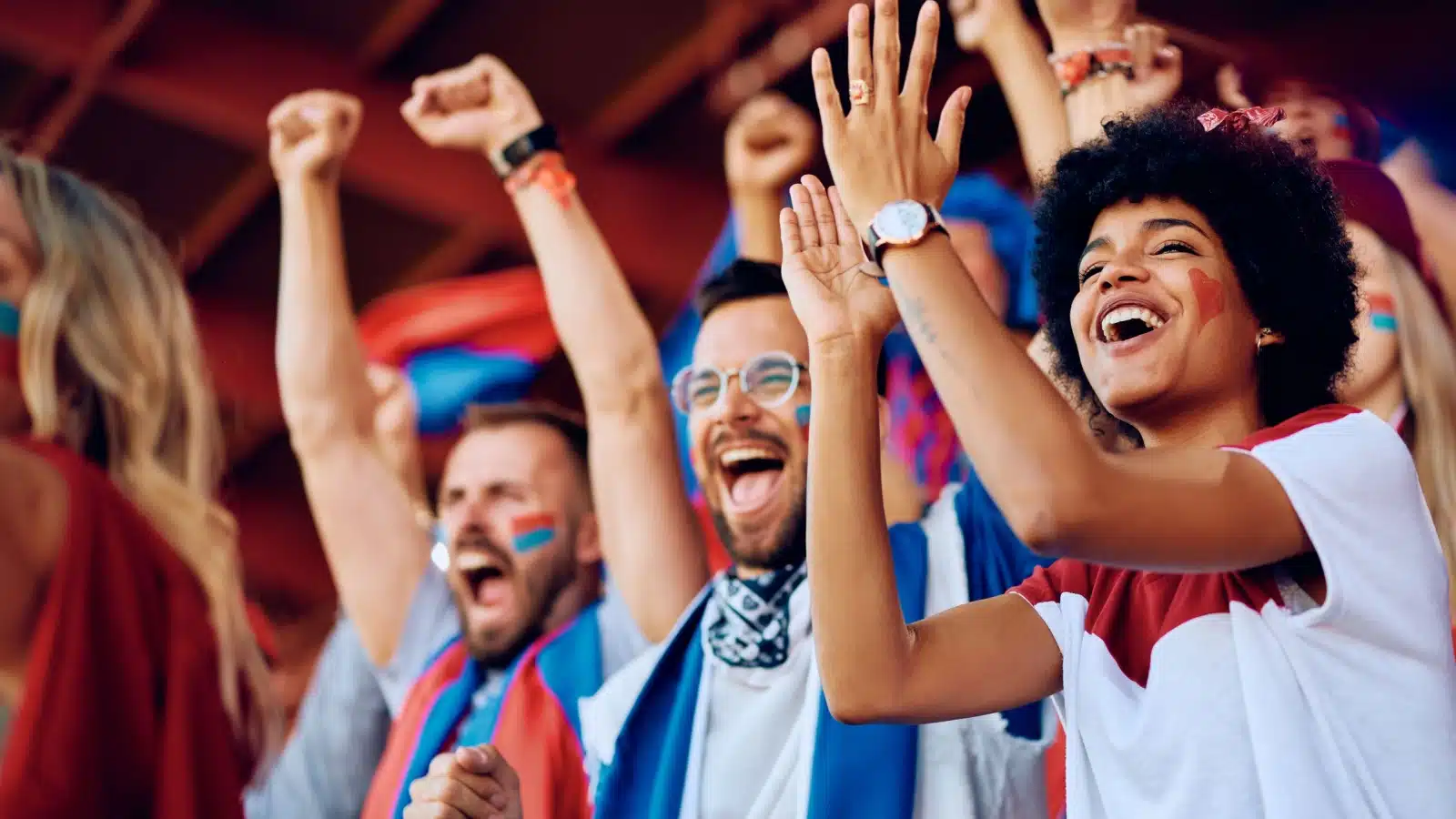 Fans cheering at a sports event.