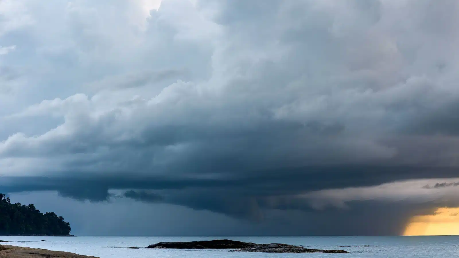 Storm clouds forming over a bay.
