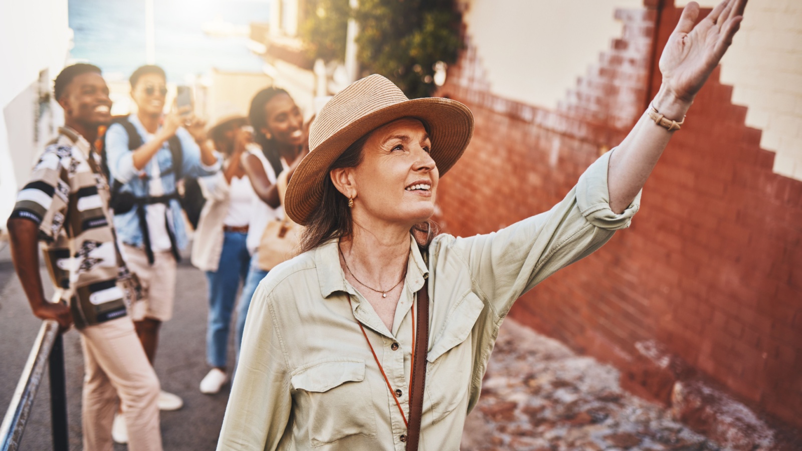 A tour guide points out a feature of interest during a walking tour.