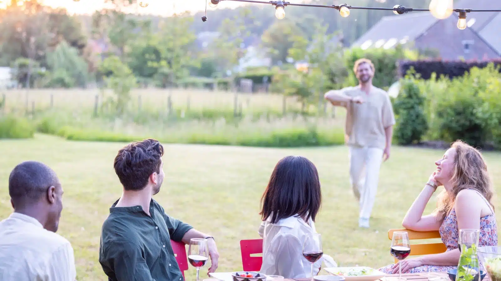 A man arrives late to an outdoor party.