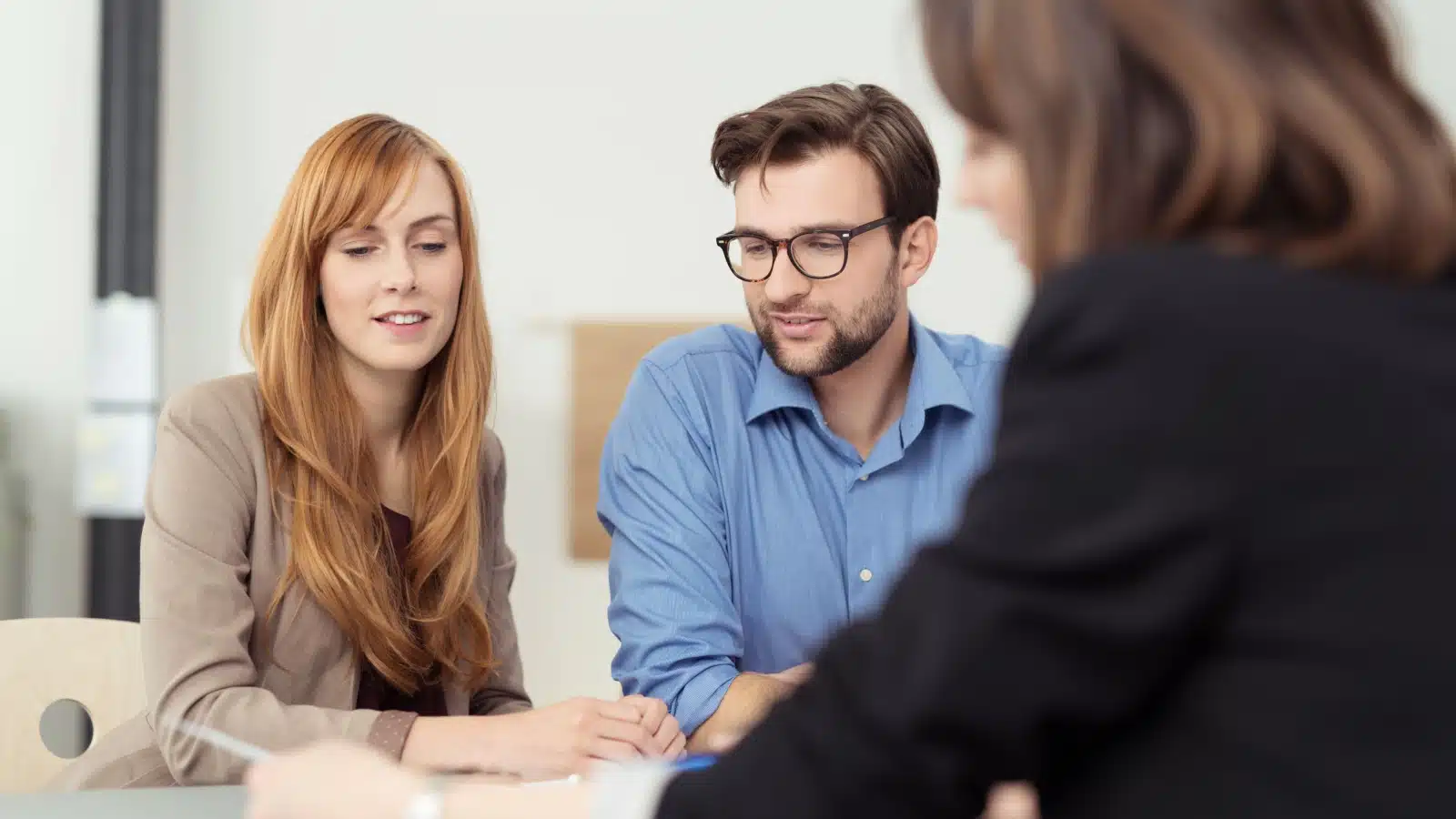 A young couple meets with a lawyer.