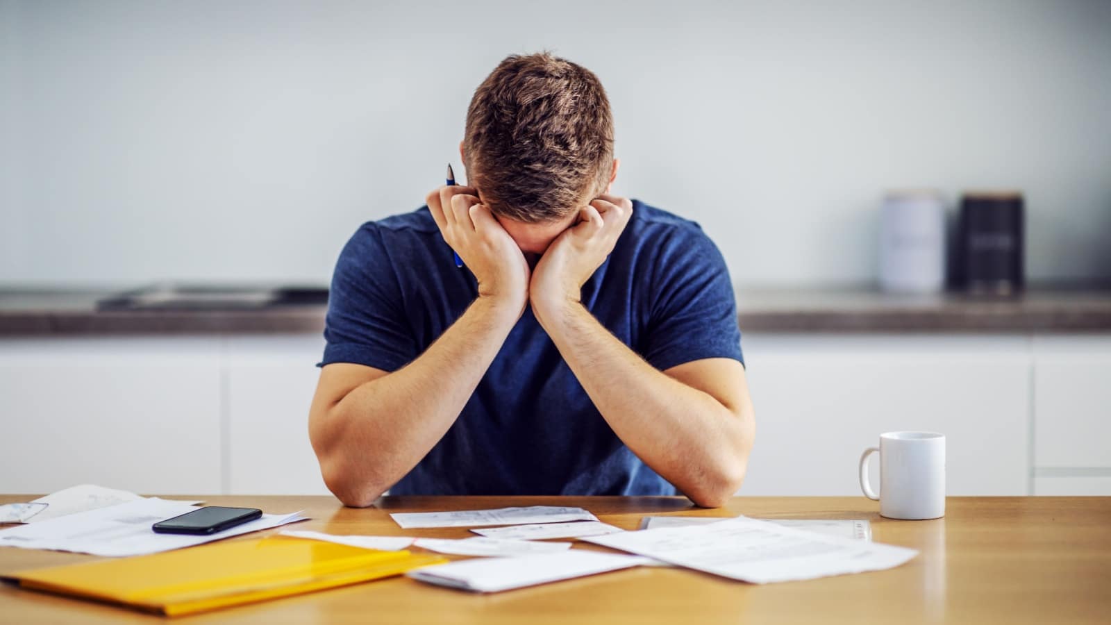 A sad, desperate man looks at his finances, realizing he can't afford the wedding. Should he empty his 401K to pay for a wedding?