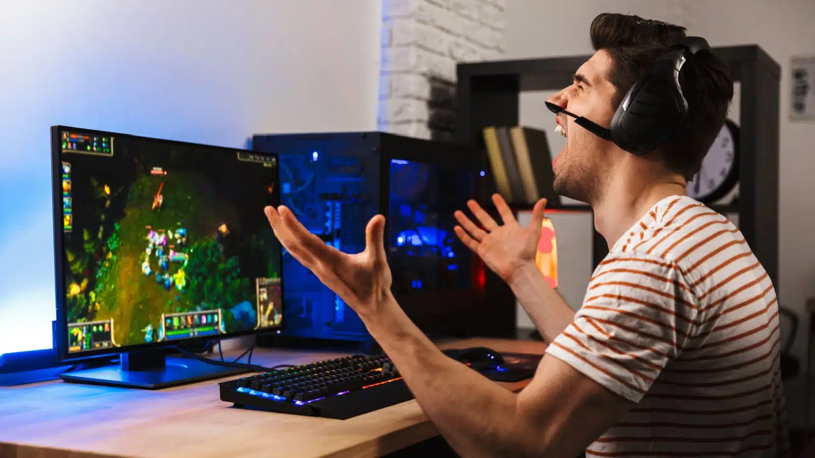 Man yelling at his computer after losing in a game to represent the hardest video games of all time.