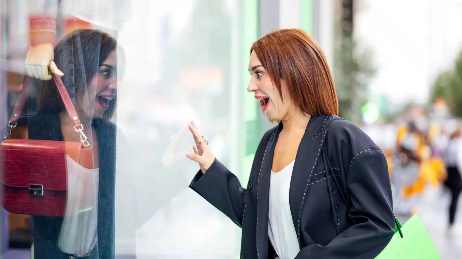 A woman gets really excited about a bag she sees in a window. She might impulsively buy it.