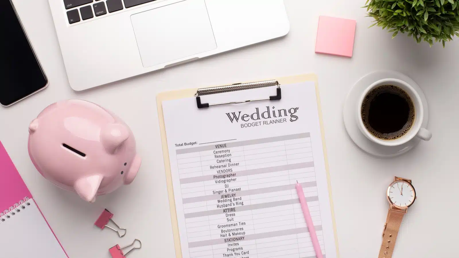 A piggy bank next to a wedding price planner to represent paying for a wedding.