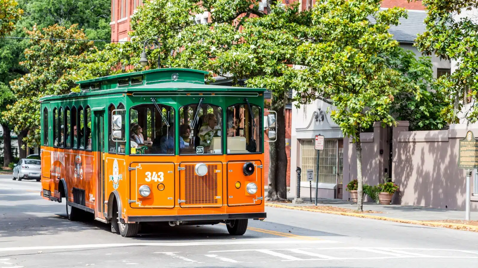 An orange and green trolly tour in Savannah, GA.